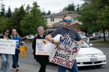 Union members march along 196th St in support of a fair contract
